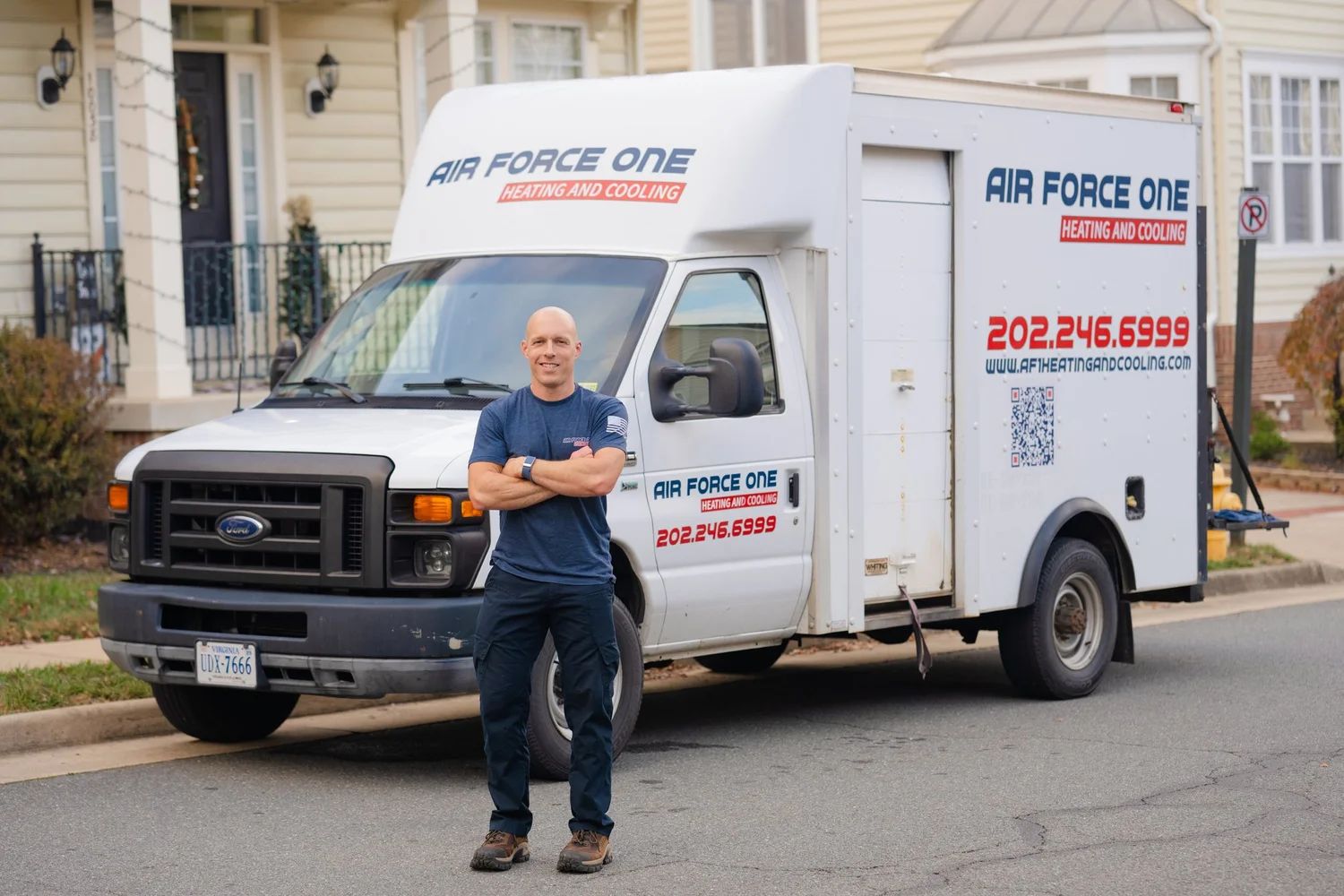 Jim, owner of Air Force One Heating and Cooling, standing in front of his service truck on a Northern Virginia street